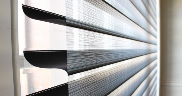 Close-up of a triple shade showing soft fabric vanes between sheer layers